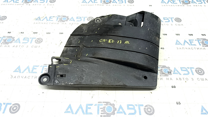 The left rear beam protection for a Mazda CX-50 23-25 is dented and torn.