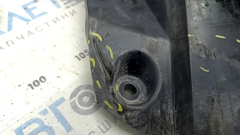 The left rear beam protection for a Mazda CX-50 23-25 is dented and torn.