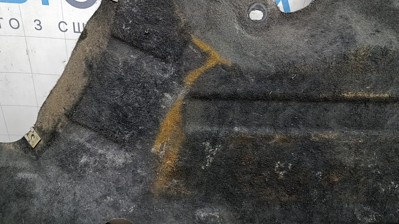 The right underbody protection of a Ford Edge 15-24 is worn and torn.