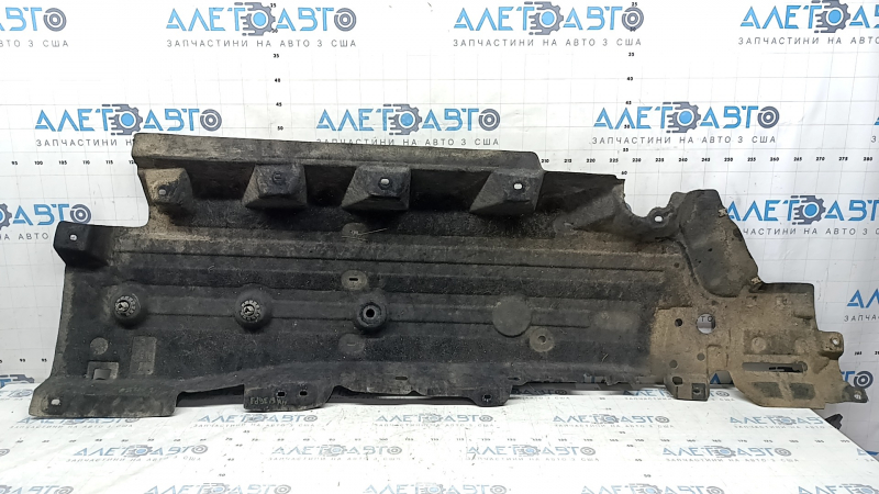 The right underbody protection of a Ford Edge 15-24 is worn and torn.
