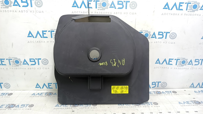 The trunk tray for the spare tire of an Audi A4 B8 08-16 sedan has scratches, a dent, and a tear.