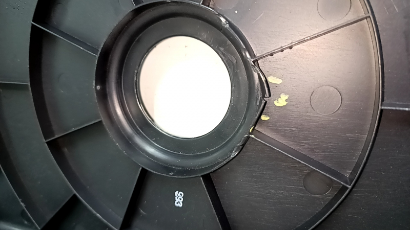 The trunk tray for the spare tire of an Audi A4 B8 08-16 sedan has scratches, a dent, and a tear.