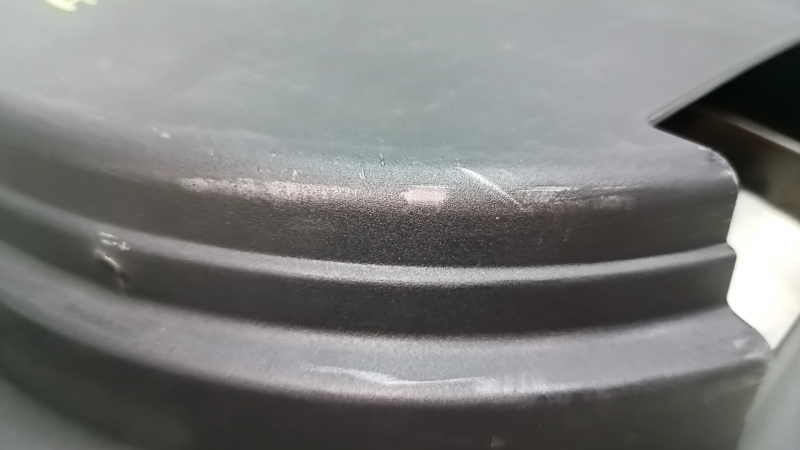 The trunk tray for the spare tire of an Audi A4 B8 08-16 sedan has scratches, a dent, and a tear.