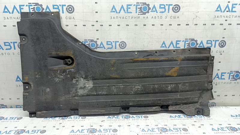 Front left underbody protection for BMW X7 G07 19-22 is dented and has tears