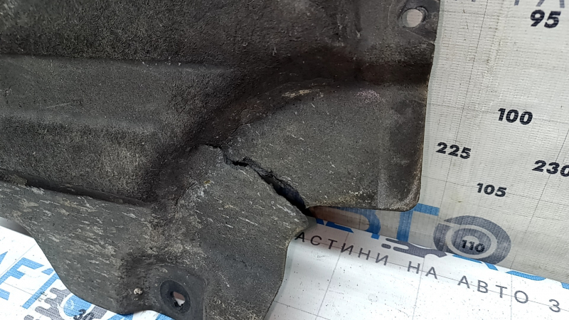 Front left underbody protection for BMW X7 G07 19-22 is dented and has tears