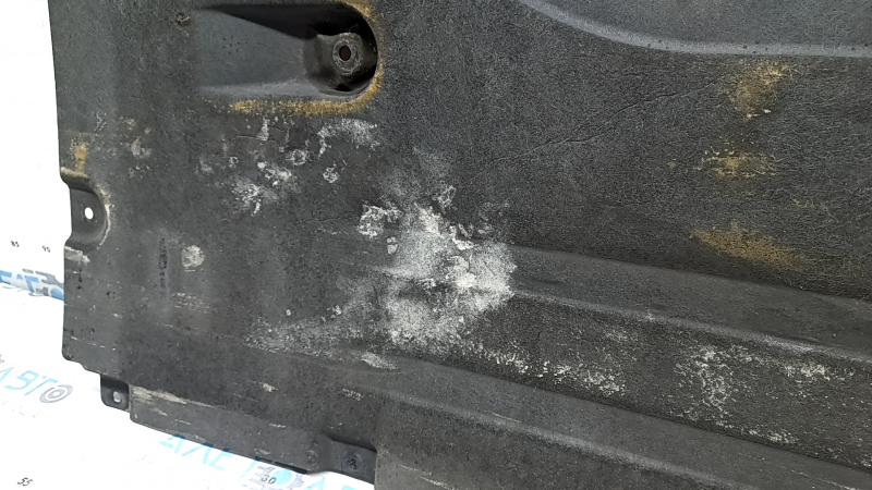 Front left underbody protection for BMW X7 G07 19-22 is dented and has tears