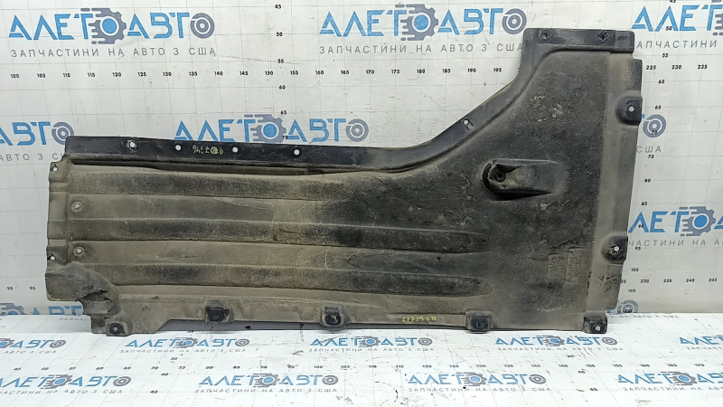 Front left underbody protection for BMW X7 G07 19-22 is dented and has tears