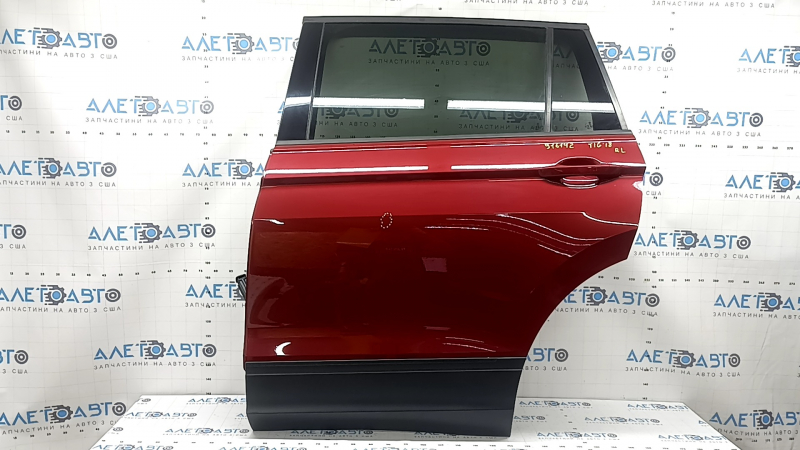 Rear left door assembly for a VW Tiguan 18-24 tinted, with black matte moldings and red LA3Q dent.