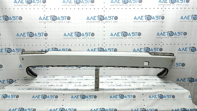 The bare lower rear bumper of a Volvo XC90 16-23, for parking sensors, white, scratches