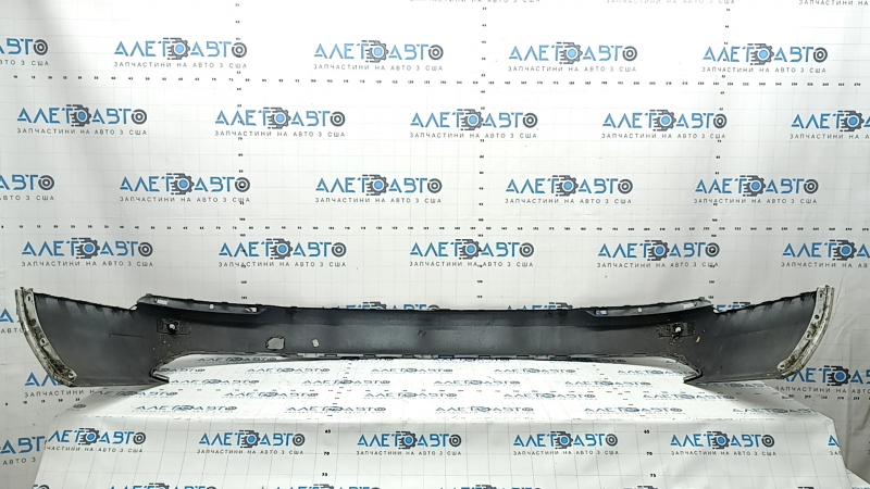 The bare lower rear bumper of a Volvo XC90 16-23, for parking sensors, white, scratches