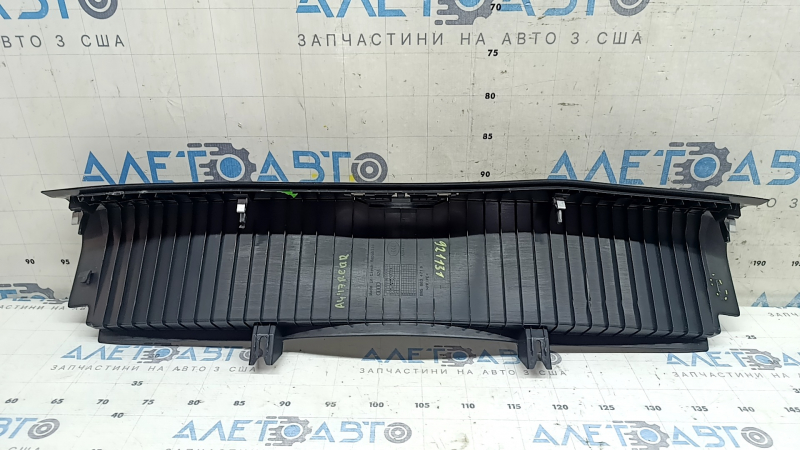 The Audi A4 B9 17-20 trunk opening trim is black, worn, and the mount is broken.