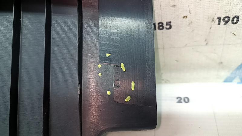 The Audi A4 B9 17-20 trunk opening trim is black, worn, and the mount is broken.