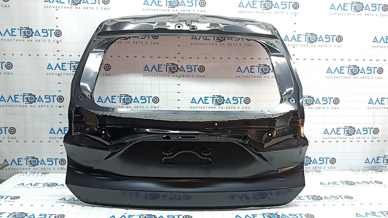 The trunk door of a Toyota Venza 21-24 is dented.