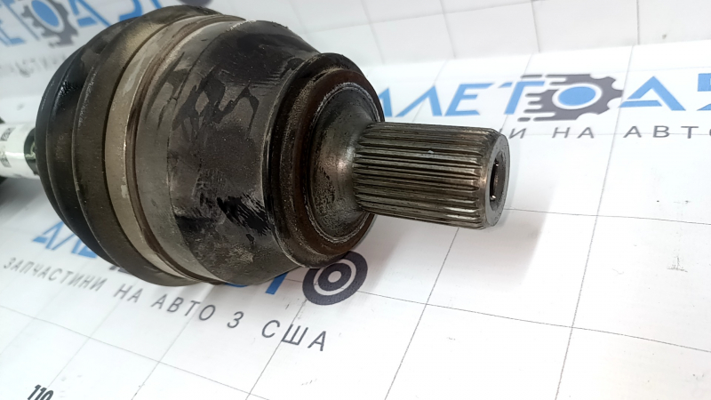 The front right drive axle shaft of a Mercedes X247 GLB 20-26 AWD has a torn boot.