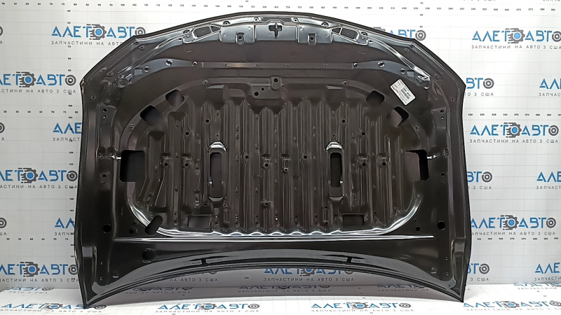 The hood of a Toyota Camry V70 18-24 aluminum is bare. The corner is bent.