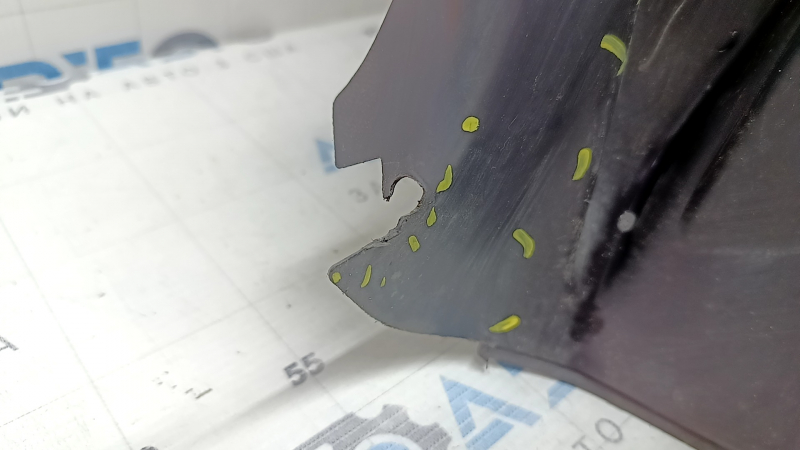 The rear right fender liner of a 19-23 Jeep Renegade is dented and the fastener is torn.