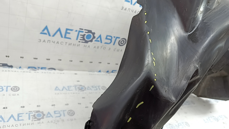 The rear right fender liner of a 19-23 Jeep Renegade is dented and the fastener is torn.