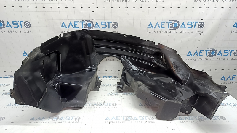 The rear right fender liner of a 19-23 Jeep Renegade is dented and the fastener is torn.
