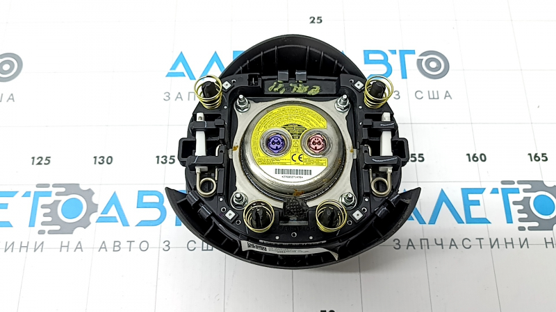 The steering wheel airbag for the driver's side of the Hyundai Elantra 21-26 is dark gray.