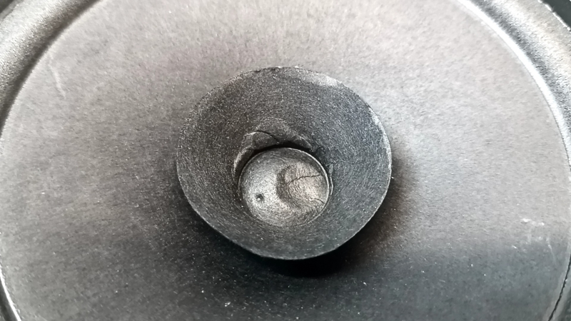 The rear left speaker of the Infiniti QX50 19-25 is dented.
