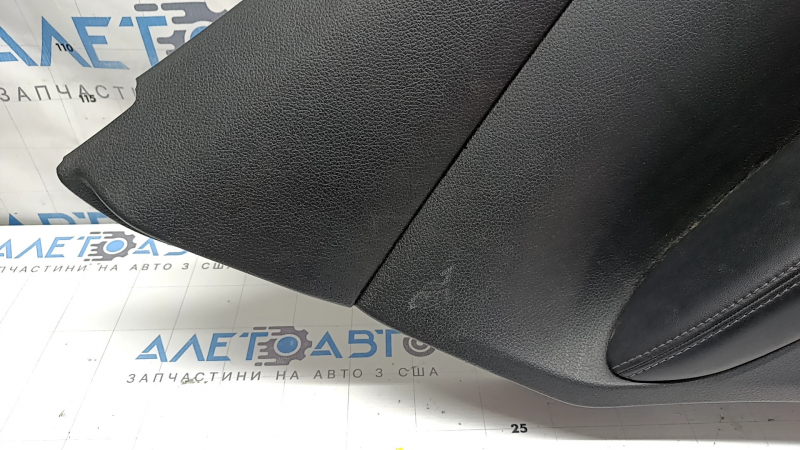 Rear left door panel for a 2022 Nissan Rogue Sport, black with black insert, black leather armrest, scratches