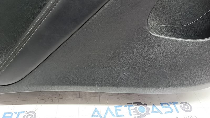 Rear left door panel for a 2022 Nissan Rogue Sport, black with black insert, black leather armrest, scratches
