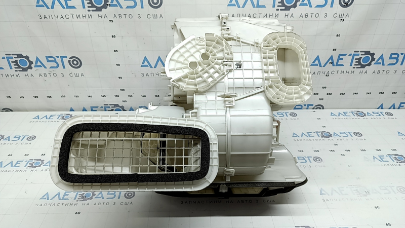 The bare heater housing of a 19-22 Nissan Rogue Sport without heated seats is broken.