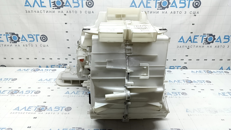 The bare heater housing of a 19-22 Nissan Rogue Sport without heated seats is broken.