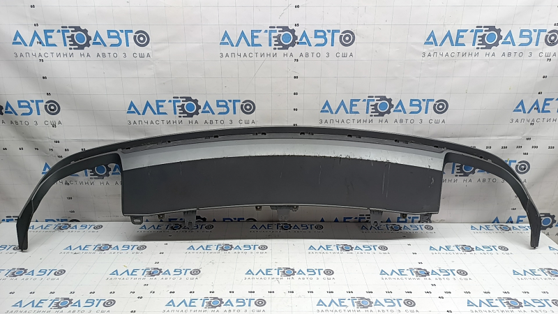 The rear bumper lip of the Audi A6 C7 16-18 restyling s-line is gray, scratches, cracked fasteners, broken fastener, chips