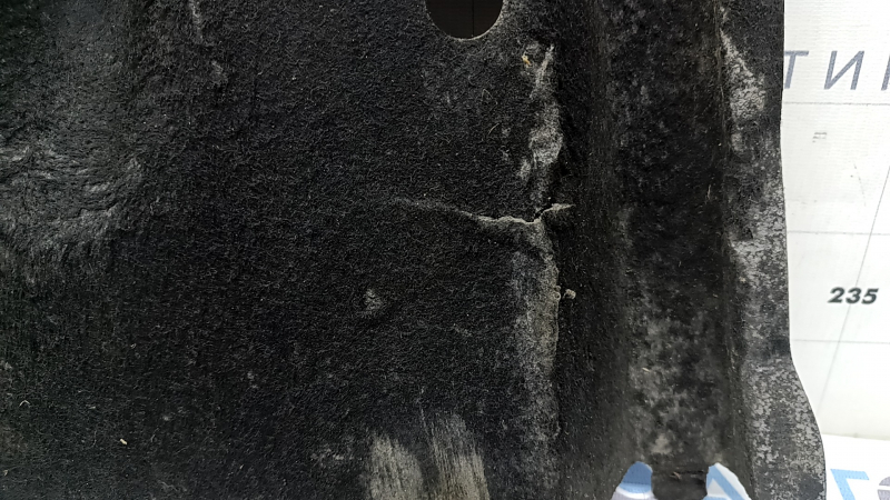 The front left underbody protection of the Audi A6 C7 12-18 is worn and torn.
