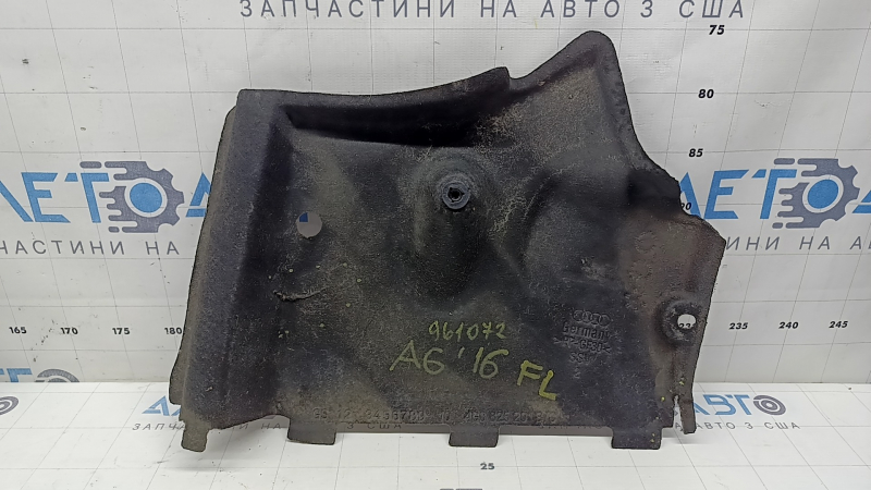 The front left underbody protection of the Audi A6 C7 12-18 is worn and torn.
