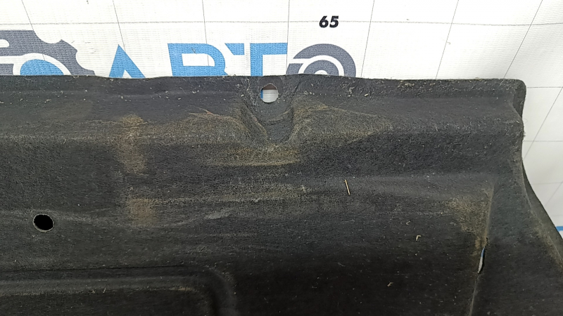The right underbody protection of a Hyundai Tucson 22-26 is dented and the fastener is torn off.
