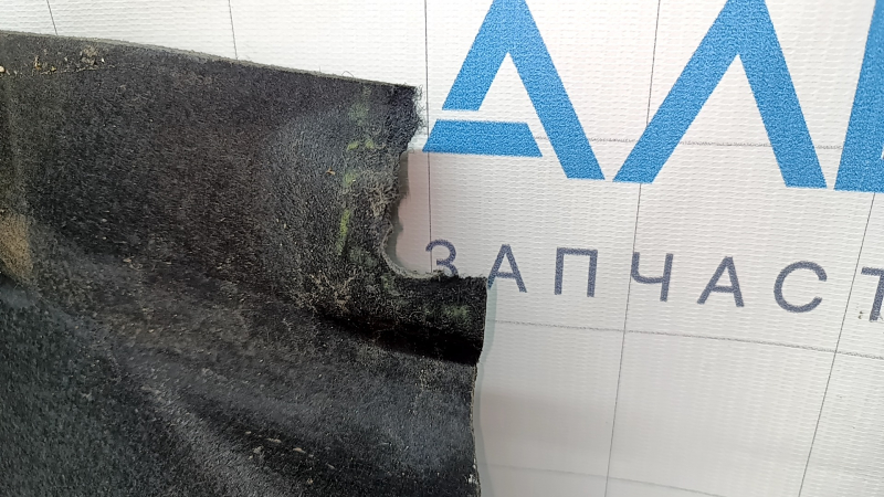 The right underbody protection of a Hyundai Tucson 22-26 is dented and the fastener is torn off.