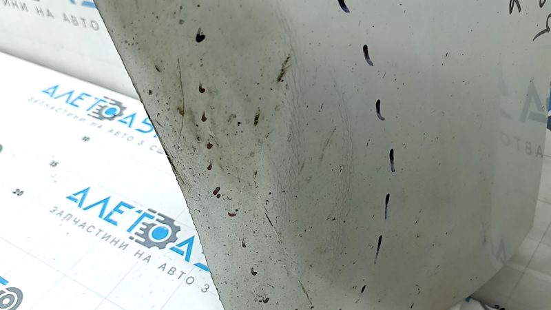 The bare lower rear bumper of a Volvo XC90 16-26 for parking sensors, white, the parking sensor mount is broken, dented, and there are cracks in the mounts.