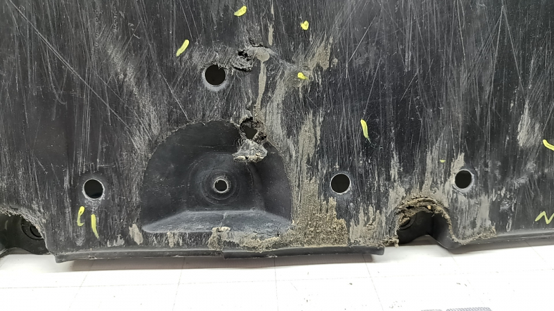 The front bumper guard of a Toyota Prius 50 16-18 is worn, torn, and dented.