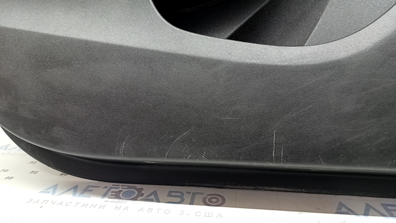 The front left door panel of a Chevrolet Volt 16 is black, with a black leather insert, the armrest is black leather, with a handle, without a trim and buttons, scratches