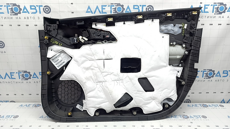 The front left door panel of a Chevrolet Volt 16 is black, with a black leather insert, the armrest is black leather, with a handle, without a trim and buttons, scratches