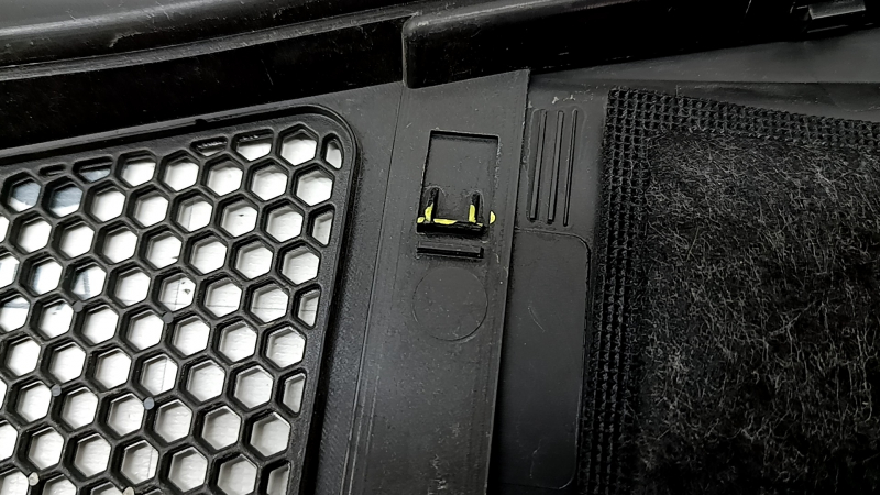 The plastic windshield wiper grille for an Audi A6 C8 19-24 has broken fasteners.