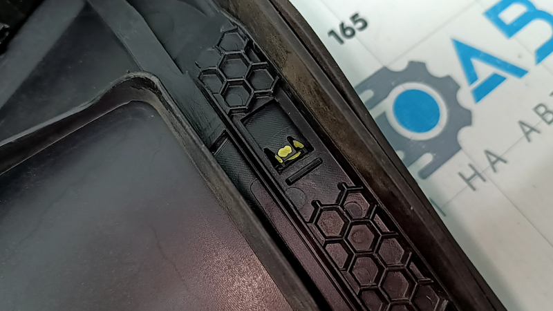 The plastic windshield wiper grille for an Audi A6 C8 19-24 has broken fasteners.