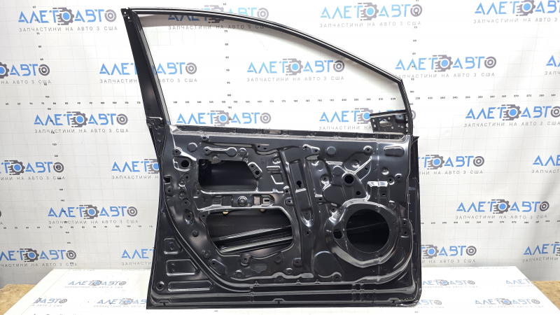 The front left door of a Toyota Prius 50 19-22 is bare and has a bent corner.