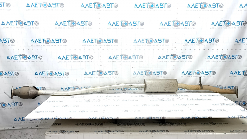 The exhaust pipe, the middle part with the catalytic converter of the Kia Sportage 23-25 2.5, is dented.