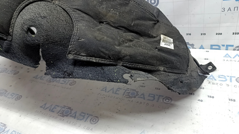 The rear left fender liner of a Hyundai Santa Fe 24-26 is torn and dented.