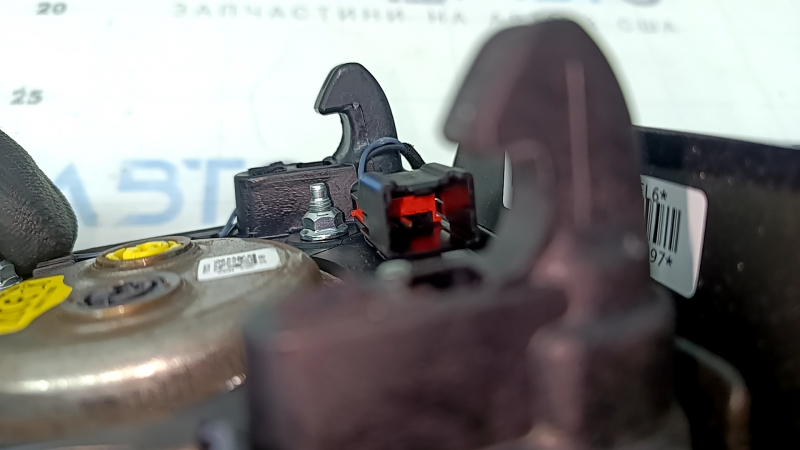 The steering wheel airbag for the driver's side of a Ford Fusion mk5 17-20 is brown and scratched.