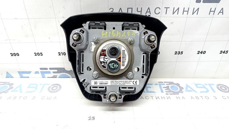 The Toyota Highlander 20-22 driver's steering wheel airbag is black and scratched.