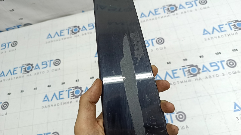 The rear right side door trim for a Lexus UX 19-26 is missing a seal, the fastener is broken, and it's covered in glue.