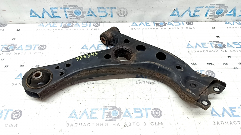 The lower front left control arm of the Lexus UX 19-26 is rusty, with microcracks.
