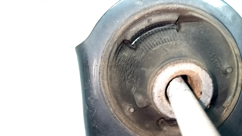 The lower front left control arm of the Lexus UX 19-26 is rusty, with microcracks.