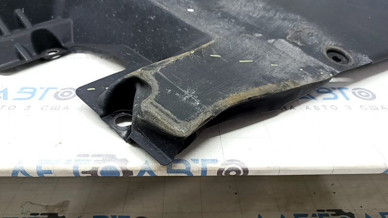 The rear left underbody protection of a Toyota Camry v70 18-24 hybrid is dented.