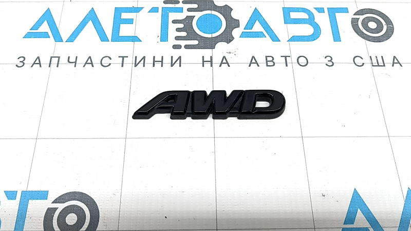 Emblem with the inscription "AWD" on the rear right door of a Toyota Rav4 19-22, glossy black