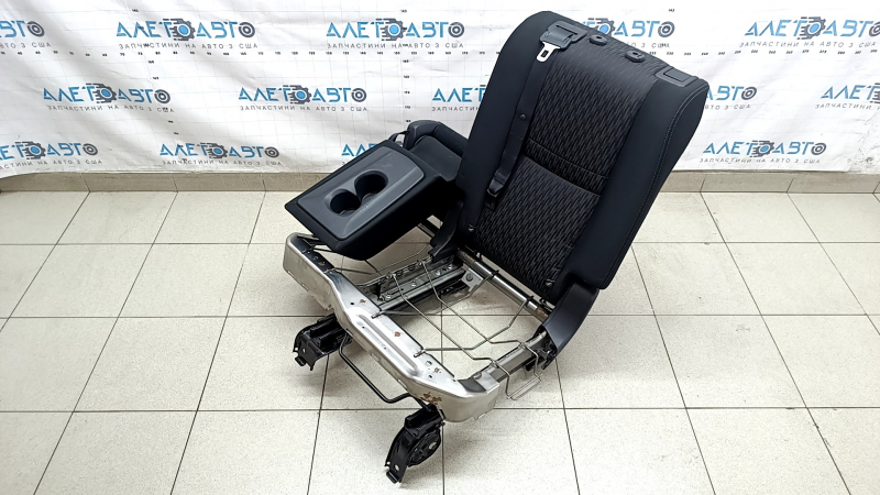 The back of the rear row of seats, 2nd row, left, Nissan Rogue 17-20, black fabric, with a belt, armrest and lower frame, is wrinkled
